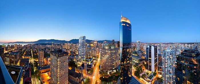 Vancouver skyline with high-rise hotel at night.