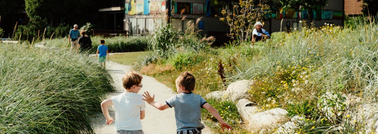 Two kids running on a path