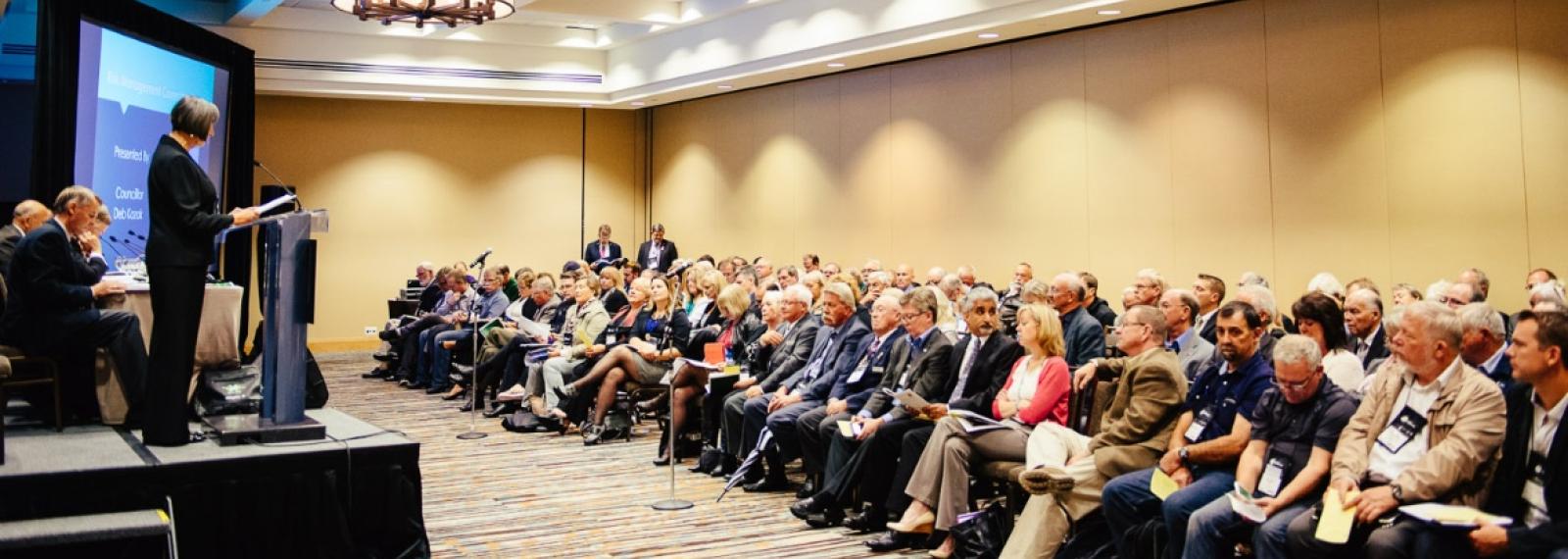 An audience listening to a speaker