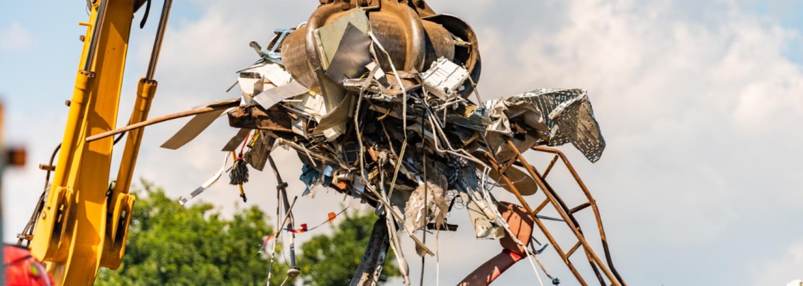 Pile of junk being moved in a junkyard