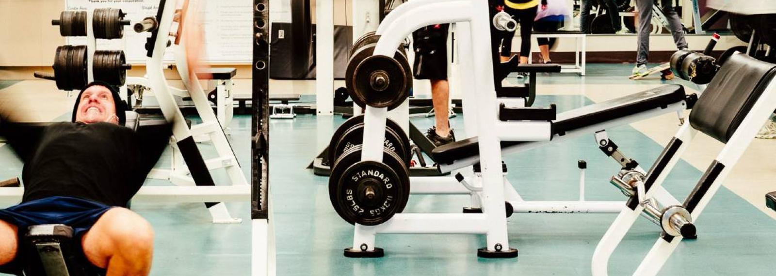 Man at the gym using a weight machine